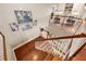 Upper staircase with gorgeous woodwork, open design, and stylish Gathering photographs hung on the wall at 9648 Weatherstone, Windermere, FL 34786