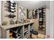 Rustic wine cellar with custom shelving, a decorative display, and storage for various drinks at 9648 Weatherstone, Windermere, FL 34786