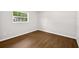 Bright bedroom with hardwood flooring and a window offering natural light at 9782 County Road 121, Wildwood, FL 34785