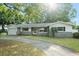 Charming single-story home featuring a well-maintained front yard and a paved driveway at 9782 County Road 121, Wildwood, FL 34785