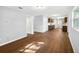 Spacious living room featuring hardwood floors and modern light gray walls at 9782 County Road 121, Wildwood, FL 34785