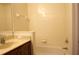 Bathroom featuring a bathtub with tiled walls and a beige tiled floor at 10115 Regent Park Dr # 2503, Orlando, FL 32825