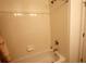 Standard white tiled bathtub with chrome shower head and faucet at 10115 Regent Park Dr # 2503, Orlando, FL 32825