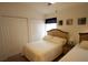 Bedroom featuring two twin beds, white closets, and a ceiling fan for added comfort at 10115 Regent Park Dr # 2503, Orlando, FL 32825