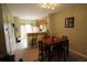 Cozy dining area featuring hardwood floors, a dining table, and a breakfast bar with modern lighting at 10115 Regent Park Dr # 2503, Orlando, FL 32825