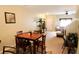 Open-concept dining area with a wooden table, adjacent to a living room with comfortable seating, and neutral decor at 10115 Regent Park Dr # 2503, Orlando, FL 32825