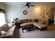Comfortable living room with a sectional sofa, staircase, ceiling fan, and cozy decor for relaxation at 10115 Regent Park Dr # 2503, Orlando, FL 32825