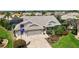 Beautiful home with three-car garage, paver driveway, and manicured landscaping at 1053 Alcove Loop, The Villages, FL 32162