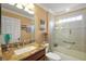 Bright bathroom with granite countertop vanity and tub-shower combo with glass enclosure, well lit at 1053 Alcove Loop, The Villages, FL 32162