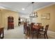 Open concept view of the dining room, living room, and kitchen with light neutral tones and tile flooring at 1053 Alcove Loop, The Villages, FL 32162