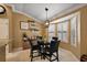 Bright dining area showcasing natural light, a modern chandelier, and stylish decor at 1053 Alcove Loop, The Villages, FL 32162