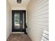 Inviting front entrance featuring a decorative glass door, sidelight, and elegant brick pavers at 1053 Alcove Loop, The Villages, FL 32162