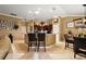 Open kitchen showcasing a kitchen island, dark wood cabinetry, and an open layout to the dining and living areas at 1053 Alcove Loop, The Villages, FL 32162