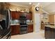 Well-appointed kitchen showcasing stainless steel oven, microwave, and cooktop, and gorgeous wood cabinetry at 1053 Alcove Loop, The Villages, FL 32162