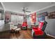Spacious living room with hardwood floors, equipped with fan and several comfortable seating areas, cozy at 1053 Alcove Loop, The Villages, FL 32162