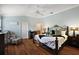 Inviting main bedroom featuring vaulted ceilings, a ceiling fan, and a decorative wrought iron bed frame at 1053 Alcove Loop, The Villages, FL 32162