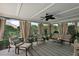 Relaxing screened patio with comfortable seating and neutral decor, perfect for enjoying the outdoors at 1053 Alcove Loop, The Villages, FL 32162