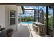 Relaxing enclosed patio features outdoor bar with views of the refreshing pool and lush landscaping at 1053 Alcove Loop, The Villages, FL 32162