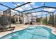 Backyard oasis with a refreshing pool, spacious patio, and shaded lounge area, perfect for summer fun at 1053 Alcove Loop, The Villages, FL 32162