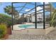 Relaxing screened-in pool with a view of the well-maintained backyard and landscaping at 1053 Alcove Loop, The Villages, FL 32162