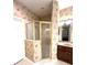 An efficient bathroom features a glass shower and coordinated wall paper, for your showering enjoyment at 108 Whispering Pines Way, Davenport, FL 33837