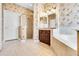 This charming bathroom includes a standalone shower and tub with coordinated wall paper at 108 Whispering Pines Way, Davenport, FL 33837