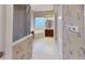 Bright bathroom boasts a soaking tub, glass shower and decorative wallpaper accents at 108 Whispering Pines Way, Davenport, FL 33837