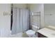 A functional bathroom features a combined shower and toilet and convenient shelf space at 108 Whispering Pines Way, Davenport, FL 33837