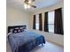 Cozy bedroom with neutral carpet flooring and abundant natural light from two sunlit windows at 108 Whispering Pines Way, Davenport, FL 33837