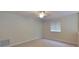 A cozy bedroom featuring carpet flooring, neutral paint, a ceiling fan, and a sunlit window at 108 Whispering Pines Way, Davenport, FL 33837