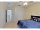 Comfortable bedroom with carpet and ceiling fan; access to additional rooms and closet at 108 Whispering Pines Way, Davenport, FL 33837