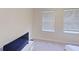 Bright bedroom with carpet and two sunlit windows, ideal for relaxing or watching TV at 108 Whispering Pines Way, Davenport, FL 33837