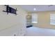 Bright bedroom featuring a white dresser, sunny window, sleek black shelving, and plush carpet at 108 Whispering Pines Way, Davenport, FL 33837