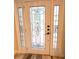 White front door with a glass design and windows on either side at 108 Whispering Pines Way, Davenport, FL 33837