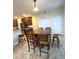 Open kitchen and dining area with modern appliances, breakfast bar seating, and ample natural light at 108 Whispering Pines Way, Davenport, FL 33837