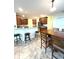 Spacious open kitchen features bar stool seating at the kitchen island, stainless appliances, and tile flooring at 108 Whispering Pines Way, Davenport, FL 33837