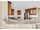 Kitchen featuring granite countertops, stainless steel appliances, and an open design at 108 Whispering Pines Way, Davenport, FL 33837
