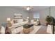 Formal living room with white couches and gold accents at 108 Whispering Pines Way, Davenport, FL 33837