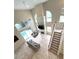 Spacious living room features vaulted ceilings, large windows, fireplace, and staircase at 108 Whispering Pines Way, Davenport, FL 33837