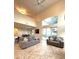 Open living area with high ceilings and large windows overlooking the pool area at 108 Whispering Pines Way, Davenport, FL 33837
