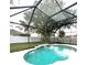 Enclosed pool with a unique waterfall feature, providing a private and serene outdoor experience at 108 Whispering Pines Way, Davenport, FL 33837