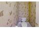 Small powder room with floral wallpaper at 108 Whispering Pines Way, Davenport, FL 33837