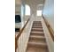 Carpeted staircase with wood railings at 108 Whispering Pines Way, Davenport, FL 33837