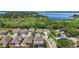 Beautiful aerial view of a neighborhood with well-maintained homes surrounded by lush greenery and a serene lake at 1155 Dora Parc Ln, Mount Dora, FL 32757