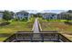 View of rear of home and backyard area, featuring a walkway and distant view of the lake at 1155 Dora Parc Ln, Mount Dora, FL 32757