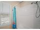 Clean white bathroom with white tiles and a shower with a shower-tub combo at 1155 Dora Parc Ln, Mount Dora, FL 32757