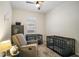 Bedroom with ceiling fan, window with blinds, and a recliner next to cages at 1155 Dora Parc Ln, Mount Dora, FL 32757