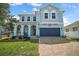 Stunning exterior elevation with a brick paver driveway leading up to the spacious two car garage at 1155 Dora Parc Ln, Mount Dora, FL 32757