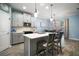 Modern kitchen with stainless steel appliances, a center island with seating, and view to dining area at 1155 Dora Parc Ln, Mount Dora, FL 32757