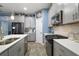 Well-appointed kitchen boasts stainless steel appliances, ample counter space, and contemporary cabinetry at 1155 Dora Parc Ln, Mount Dora, FL 32757